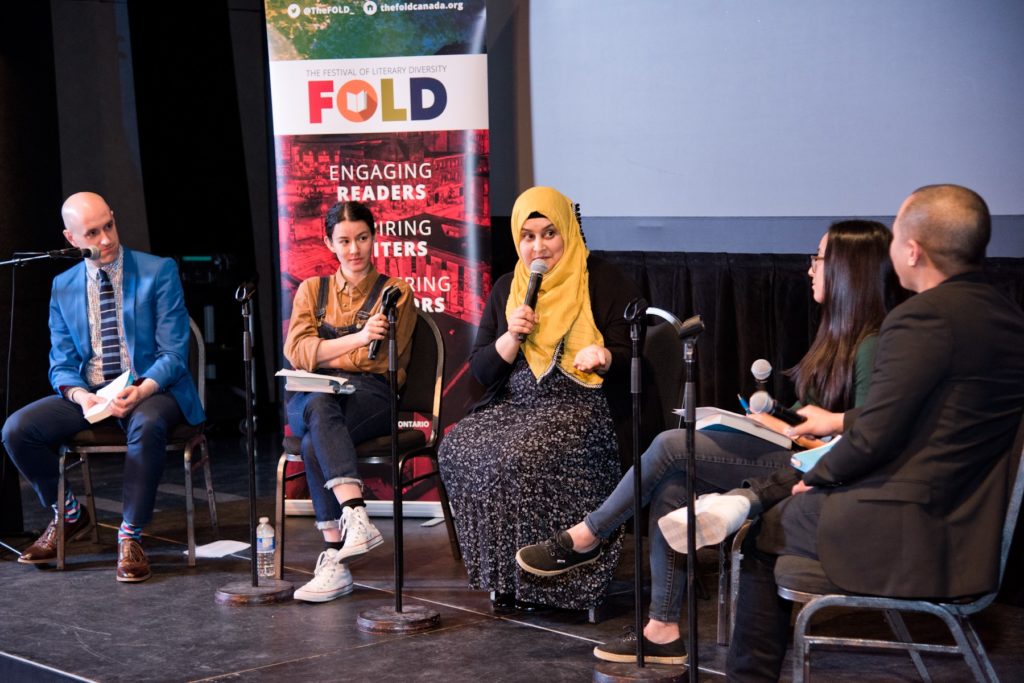 A photo of a panel of authors speaking on stage at the Festival of Literary Diversity.