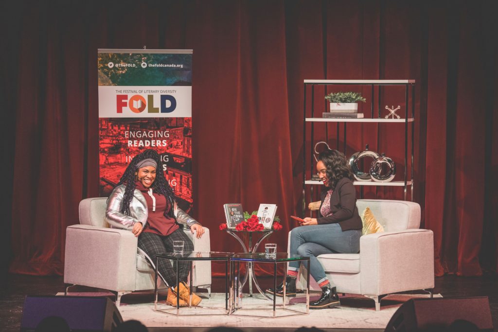 A photo of author Angie Thomas (left) being interviewed at the Festival of Literary Diversity.