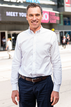Simon Foster standing and posing for a photo.