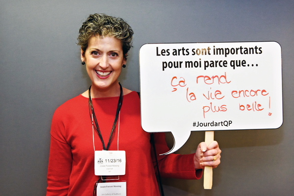 Josée Forest-Niesing holding a sign that says, "The arts are important to me because they make life even more beautiful!" at Arts Day at Queen’s Park in 2016.
