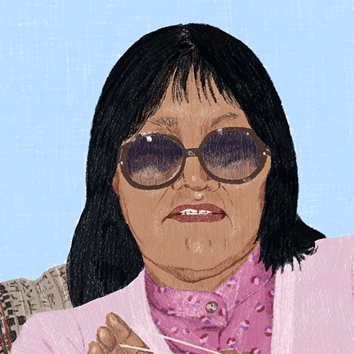  Illustration of an elderly Inuk woman, the artist’s great grandmother, sitting in an armchair wearing a light pink cardigan and tinted glasses against a pale blue background. The woman is using string to form a figure.